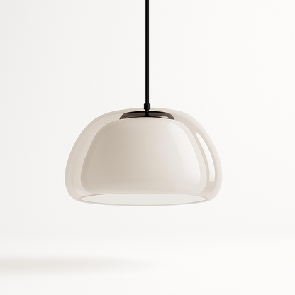 Modern Zabda pendant light by Residence Supply with sleek design and metal finish, hanging from ceiling with a warm glow.