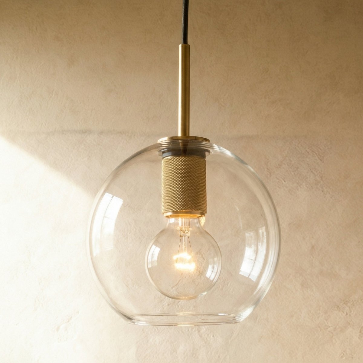 Modern Zafiris Pendant Light by Residence Supply with a sleek metal frame and clear glass shade, hanging from a ceiling mount.